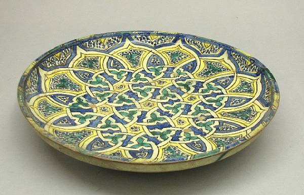 Appraisal: A Persian glazed earthenware charger th th century Painted with