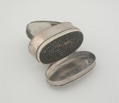 Appraisal: A George III nutmeg grater oval with a hinged base