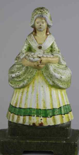 Appraisal: LADY HOLDING FRUIT DOORSTOP Judd Co depicts lady on base