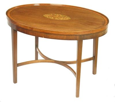 Appraisal: A mahogany oval top coffee table with a central patarae