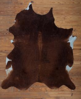 Appraisal: Cowhide ' x ' Rug Naturally soft brown and white