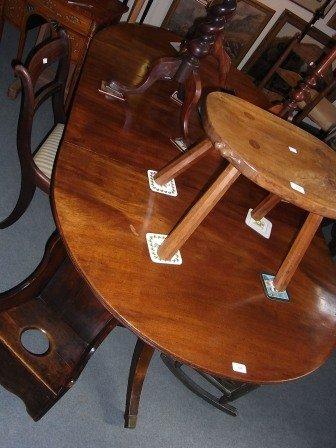 Appraisal: A MAHOGANY D-END DINING TABLE with one extra leaf on