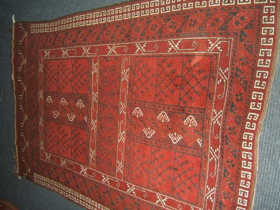 Appraisal: A Persian red ground rug cm x cm