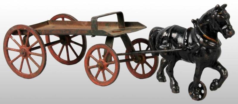 Appraisal: Cast Iron Horse-Drawn Flat Bed Wagon Toy Description Pulled by