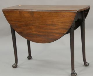 Appraisal: George II style mahogany table with oval drop leaves on