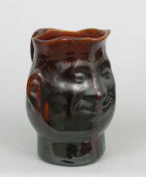 Appraisal: A Rockingham or Bennington Face Pitcher A Rockingham or Bennington