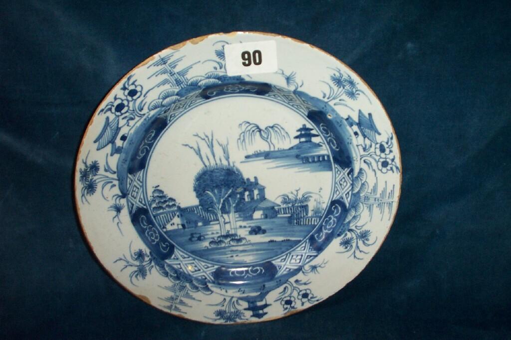 Appraisal: An th century tin glazed Delft plate with Chinoiserie landscape