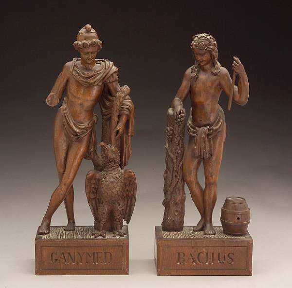 Appraisal: A pair of German carved oak figures of Ganymede and