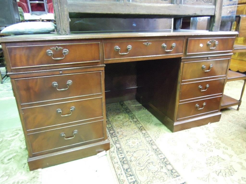 Appraisal: A reproduction mahogany kneehole pedestal desk in the Georgian style