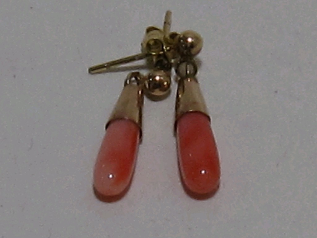 Appraisal: Nine carat gold mounted coral drop earrings