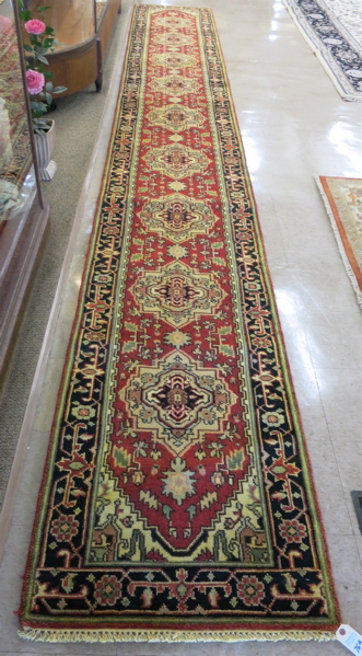 Appraisal: HAND KNOTTED ORIENTAL LONG RUG Persian Serapi design of repeating