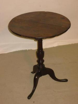 Appraisal: A GEORGE III OAK TRIPOD TABLE the circular top on