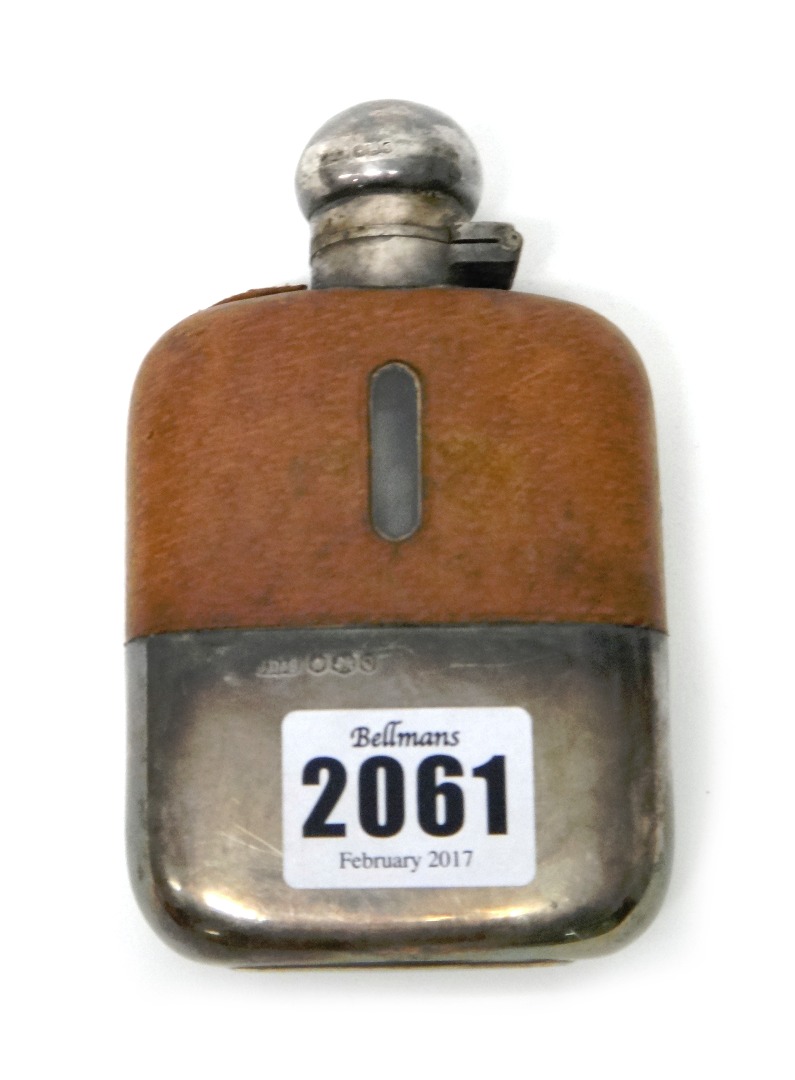 Appraisal: A silver mounted glass spirit flask partly leather covered the