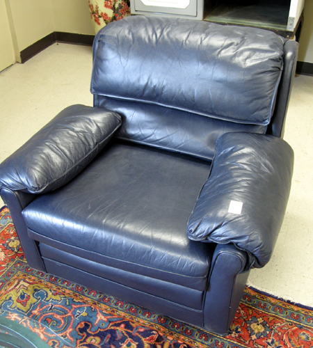 Appraisal: A PAIR OF BLUE LEATHER ARMCHAIRS WITH MATCHING OTTOMAN Classic