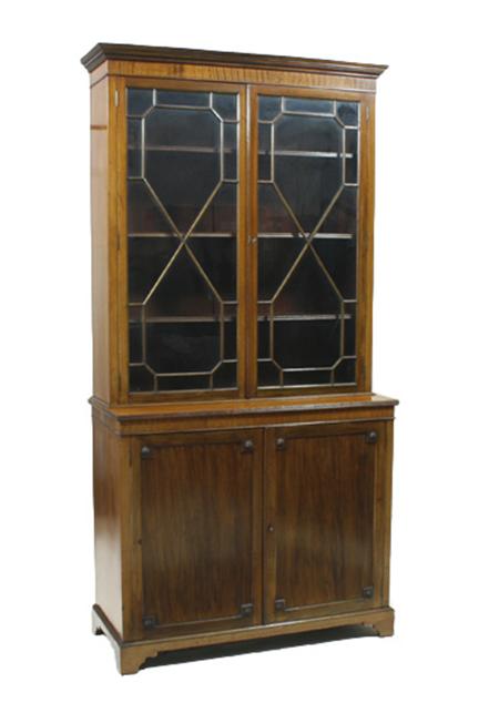 Appraisal: A Georgian style mahogany bookcase the projected moulded cornice over