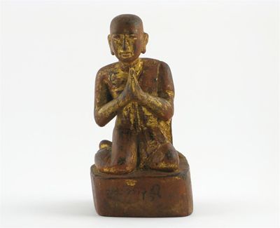 Appraisal: A Japanese carved wood figure of Buddha kneeling in prayer