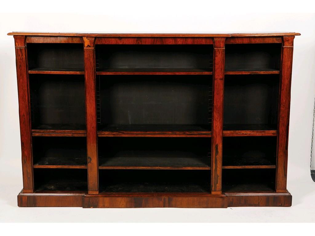 Appraisal: AN EARLY VICTORIAN ROSEWOOD BREAKFRONT OPEN FRONTED BOOKCASE the shaped