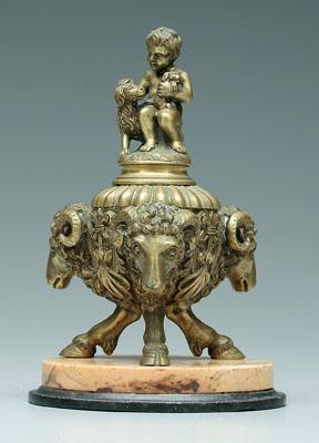 Appraisal: Bronze inkwell three rams' heads hoof feet finial with seated