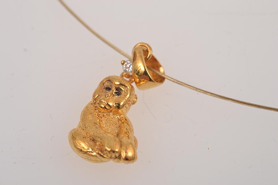 Appraisal: AN OMEGA NECKLACE WITH DIAMOND SET MONKEY PENDANT IN CT