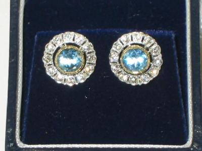 Appraisal: A PAIR OF AQUAMARINE AND DIAMOND FLOWER STUD EARRINGS with