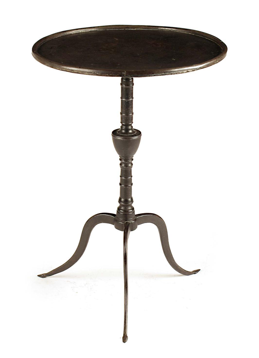 Appraisal: An early th century iron trivet modelled as a tripod