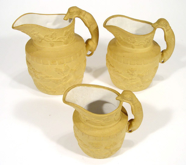 Appraisal: Graduated set of three th Century pottery jugs with greyhound