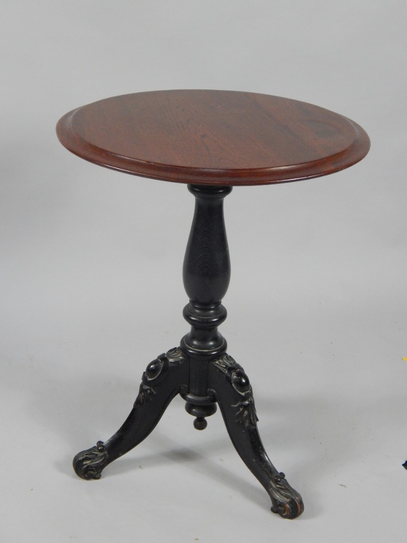 Appraisal: A Victorian circular oak occasional table raised on an ebonised