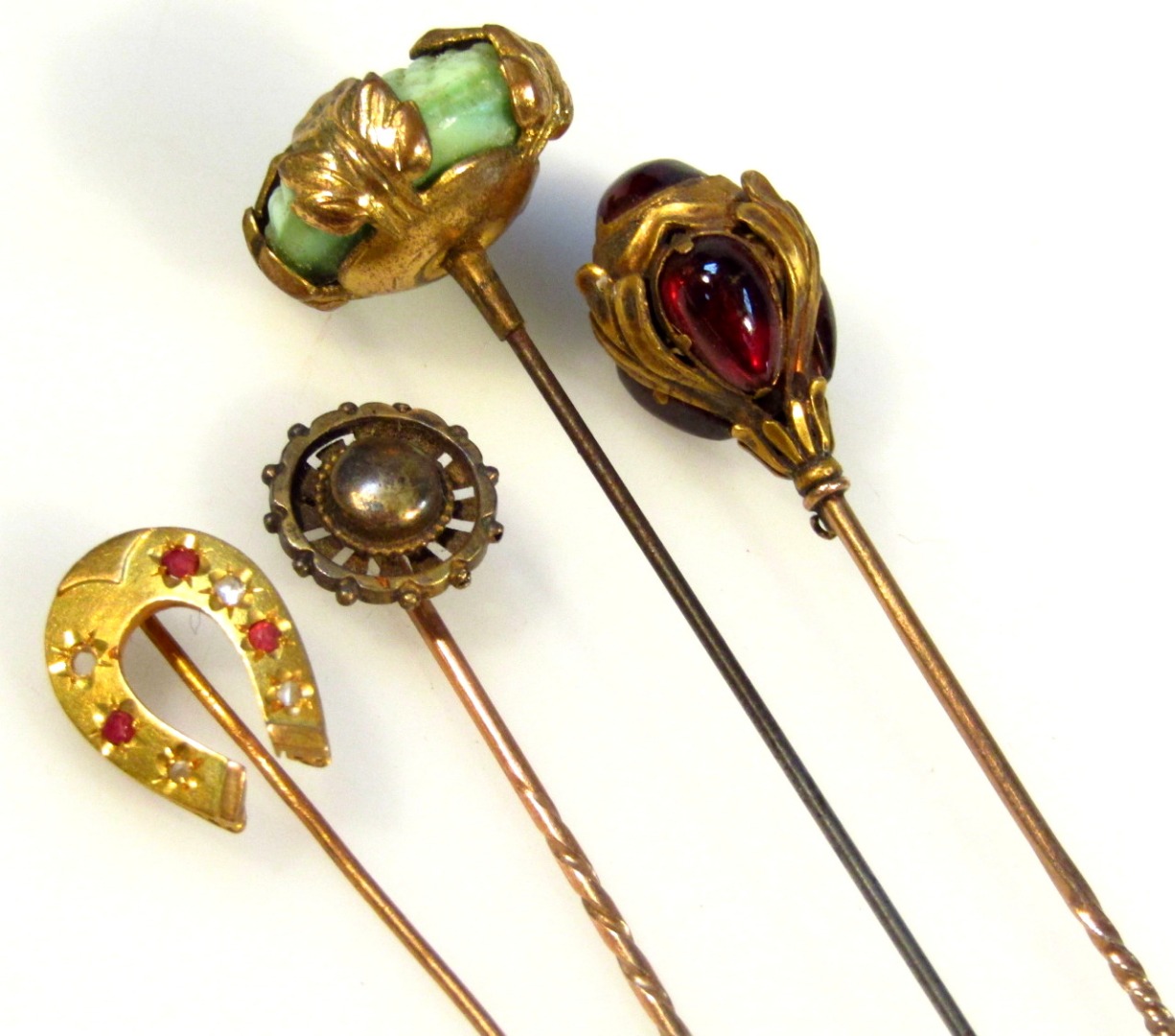 Appraisal: Four various stick pins comprising of an horseshoe example set