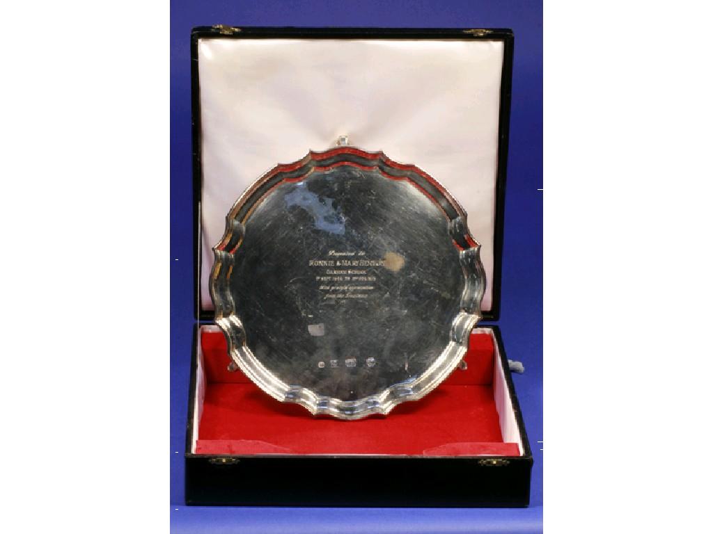 Appraisal: A PRESENTATION SALVER of shaped circular form on leaf-capped scroll