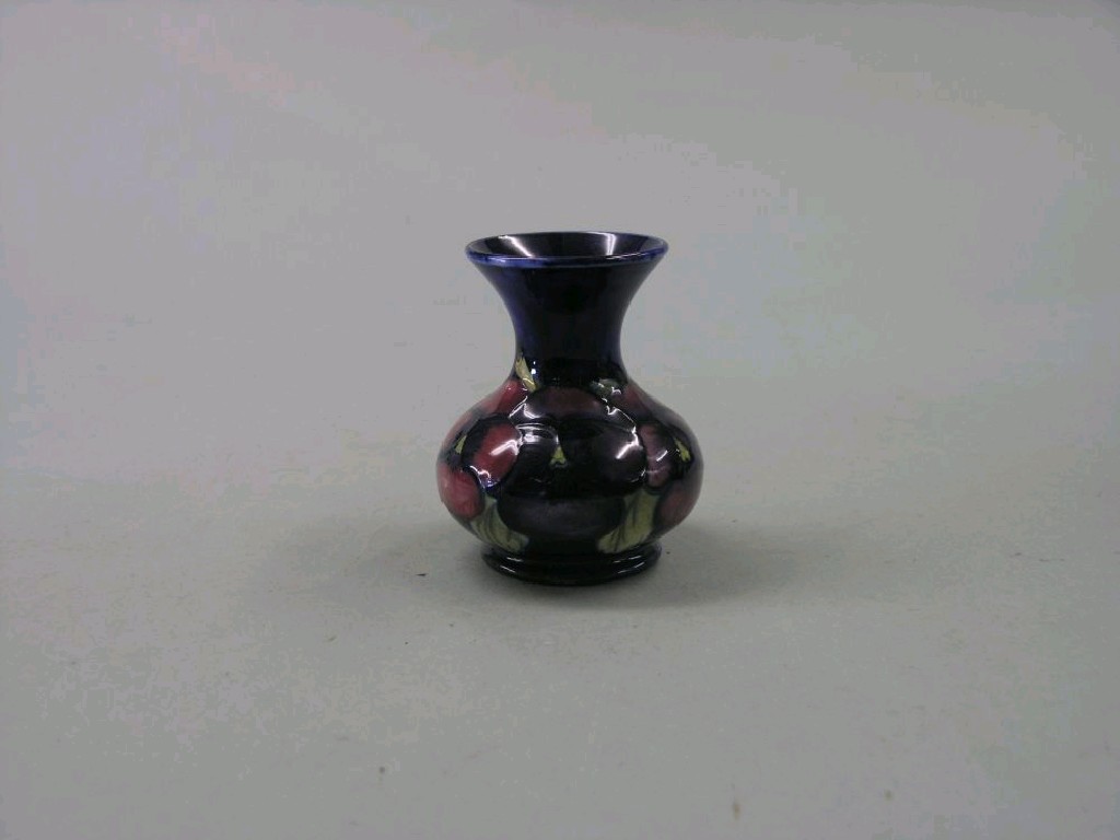 Appraisal: A small Moorcroft posy vase 'Pansy' baluster shape painted against