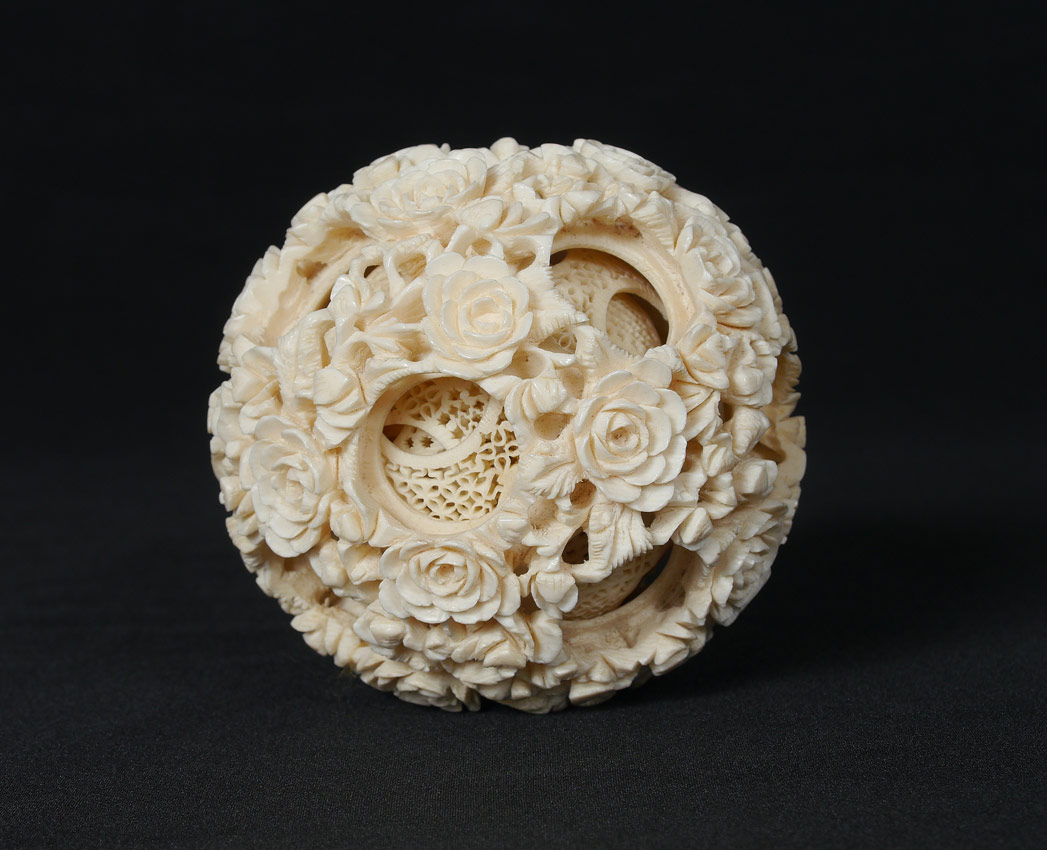 Appraisal: CARVED IVORY MYSTERY BALL With floral outer motif at least