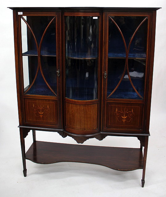 Appraisal: AN EDWARDIAN MAHOGANY INLAID GLAZED BOW FRONTED DISPLAY CABINET the