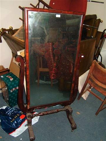 Appraisal: An early Victorian cheval mirror the rectangular glass on scrolling