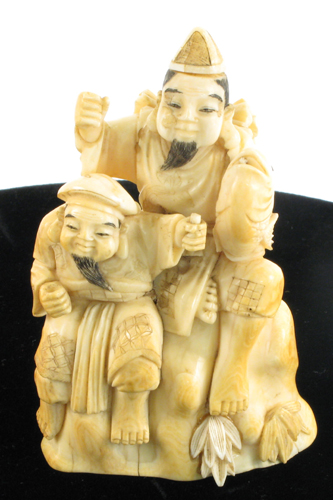 Appraisal: JAPANESE IVORY OKIMONO figural group man with bamboo cane holding