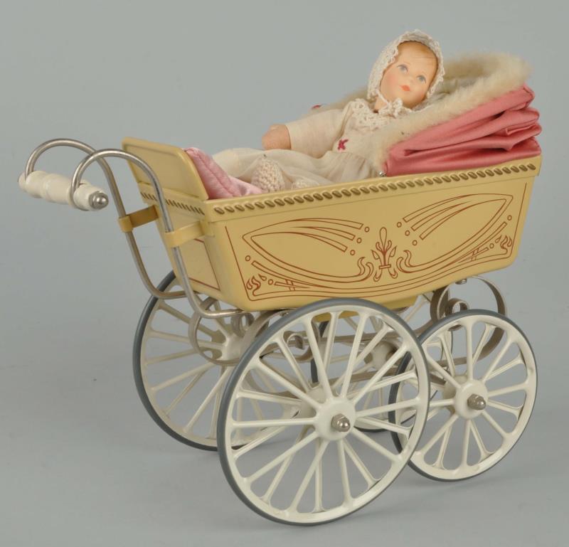 Appraisal: Tin Toy Baby Carriage With Doll This toy baby carriage