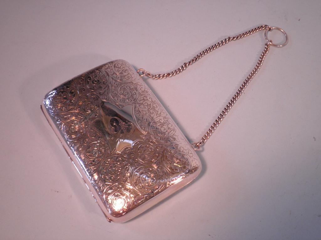 Appraisal: A Victorian silver evening purse engraved with scrolls and a