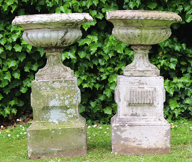 Appraisal: A PAIR OF CAST CONCRETE URNS OF CLASSICAL FORM on