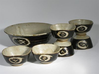 Appraisal: A stoneware bowl and six side bowls designed by Warwick