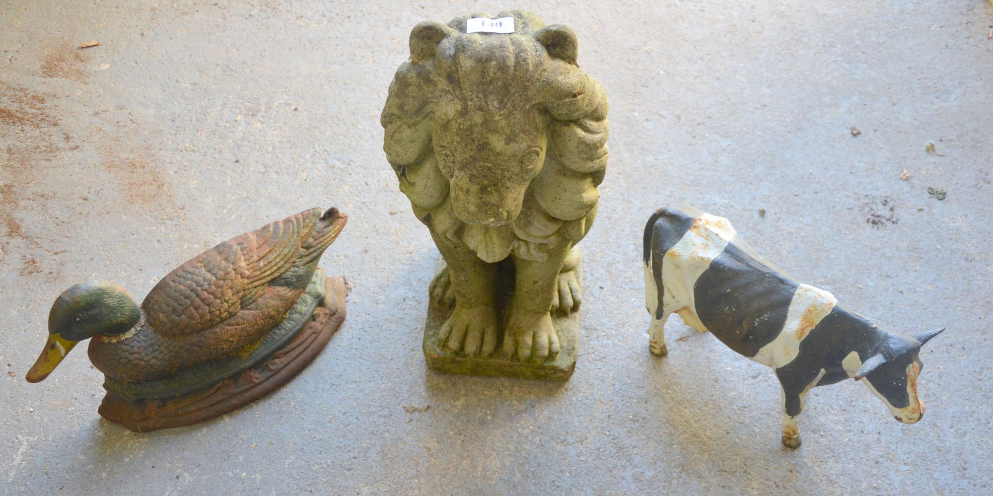 Appraisal: Composition stone garden lion and two metal painted novelty garden