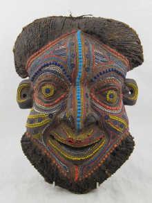 Appraisal: A carved wood African tribal mask with detailed multi-coloured bead