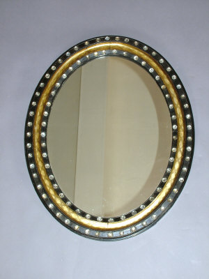 Appraisal: An ebonised oval wall mirror late th century with engraved