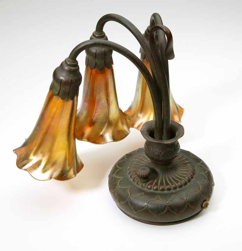 Appraisal: A Tiffany Studios patinated bronze and Favrile art glass three-light