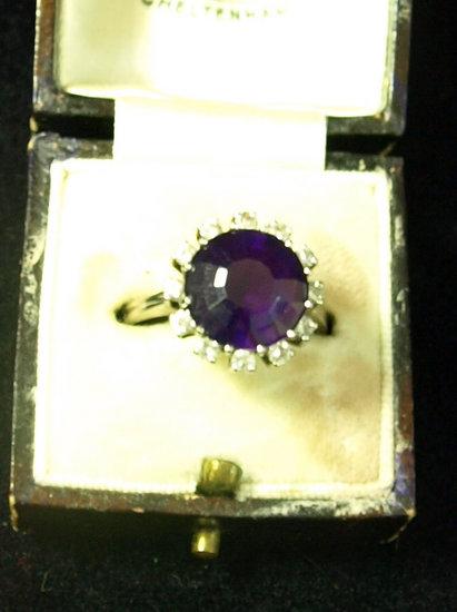 Appraisal: An amethyst half hoop ring with surround of twelve diamonds