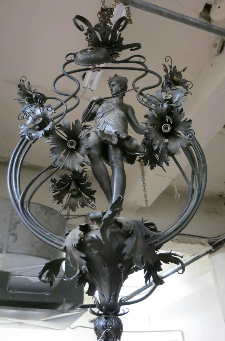 Appraisal: ART NOUVEAU STYLE FIGURAL METAL CHANDELIER featuring the standing figure