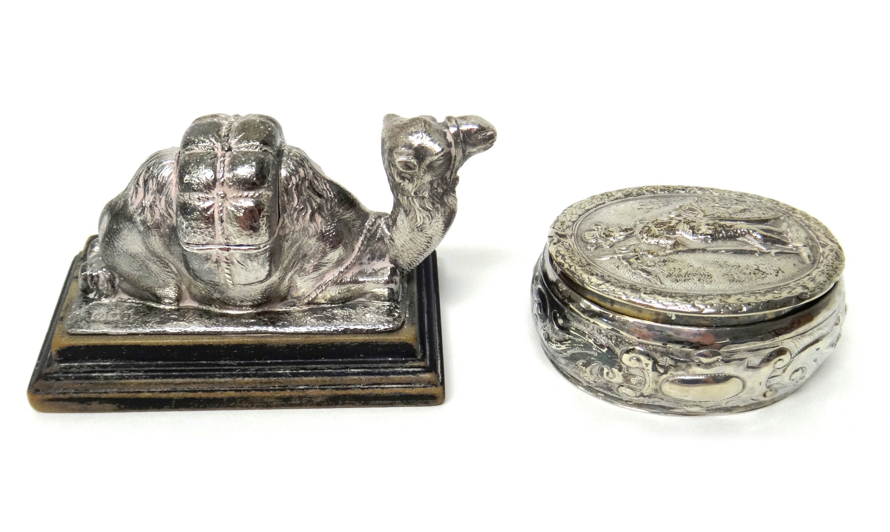 Appraisal: A silver model of a resting camel on an ebonised