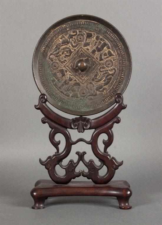 Appraisal: Chinese bronze hand mirror in the Han manner with carved