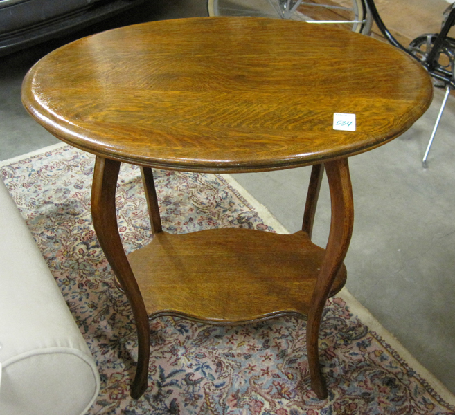 Appraisal: AN OVAL OAK LAMP TABLE American c the four S-curve