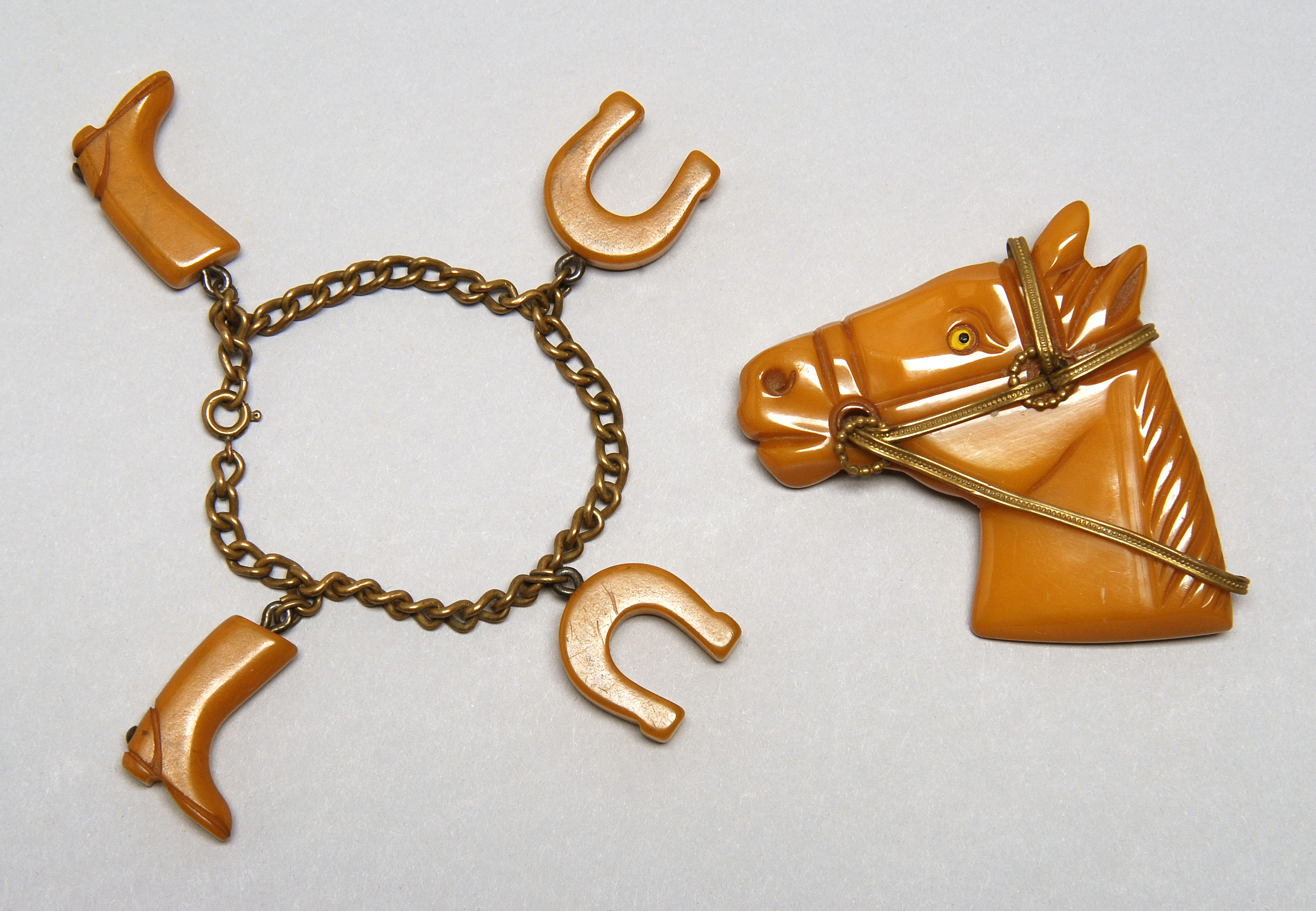 Appraisal: EQUESTRIAN-THEME BAKELITE BROOCH AND BRACELET Brooch formed as a horse's