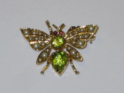 Appraisal: A SEED PEARL AND PERIDOT BROOCH modelled as a fly