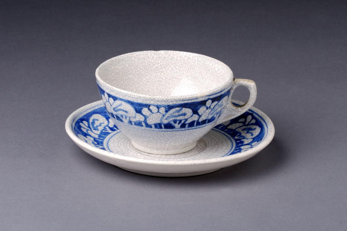 Appraisal: DEDHAM POTTERY 'SNOWTREE' PATTERN TEACUP AND SAUCER Painted in medium